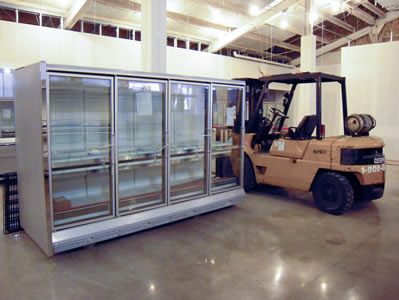 Inside store view of a forklift next to a four door case